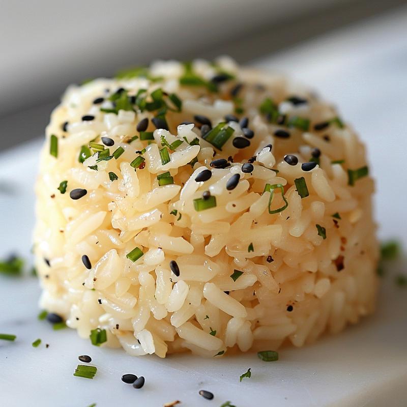 Close-up of a beautifully presented portion of leftover rice with vibrant garnishes on a white marble surface.